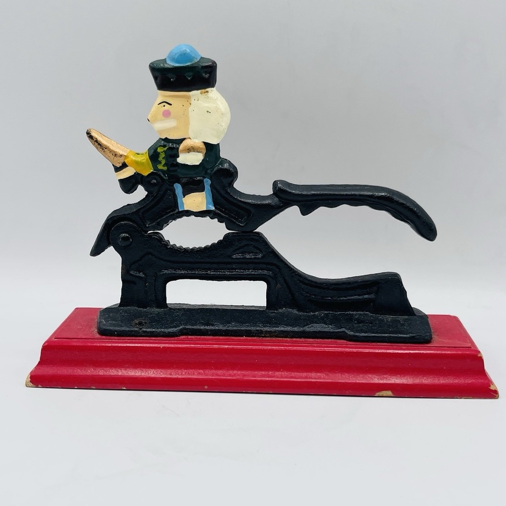 Vintage Cast Iron Nutcracker Solider on Wooden platform
